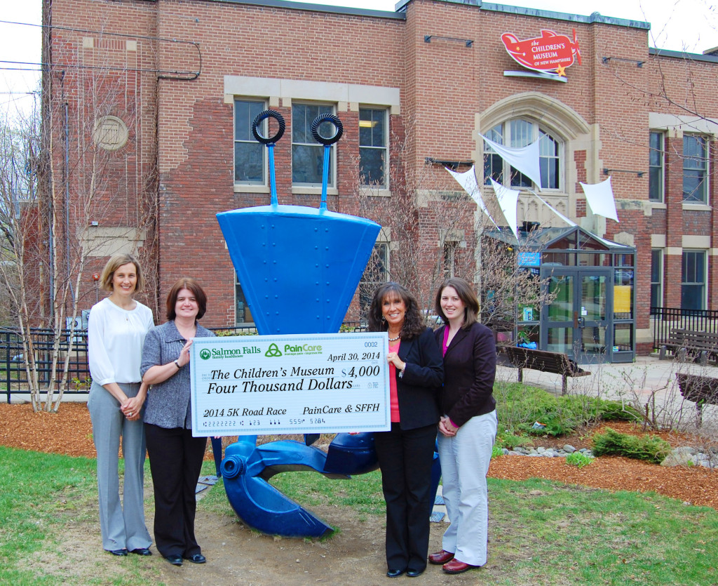 From Left to Right: Childrens' Museum Membership Manager, Katie West, and President, Jane Bard, receiving a check from Salmon Falls Practice Manager, Dawn Daigle, and Pinewood Healthcare Administrator, Stephanie Caucis